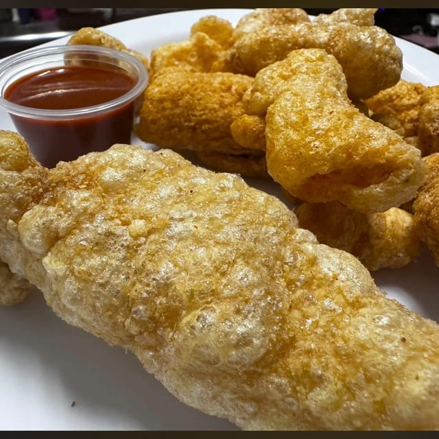 Chicarrones (pork rinds w/Salsa Valentina).
